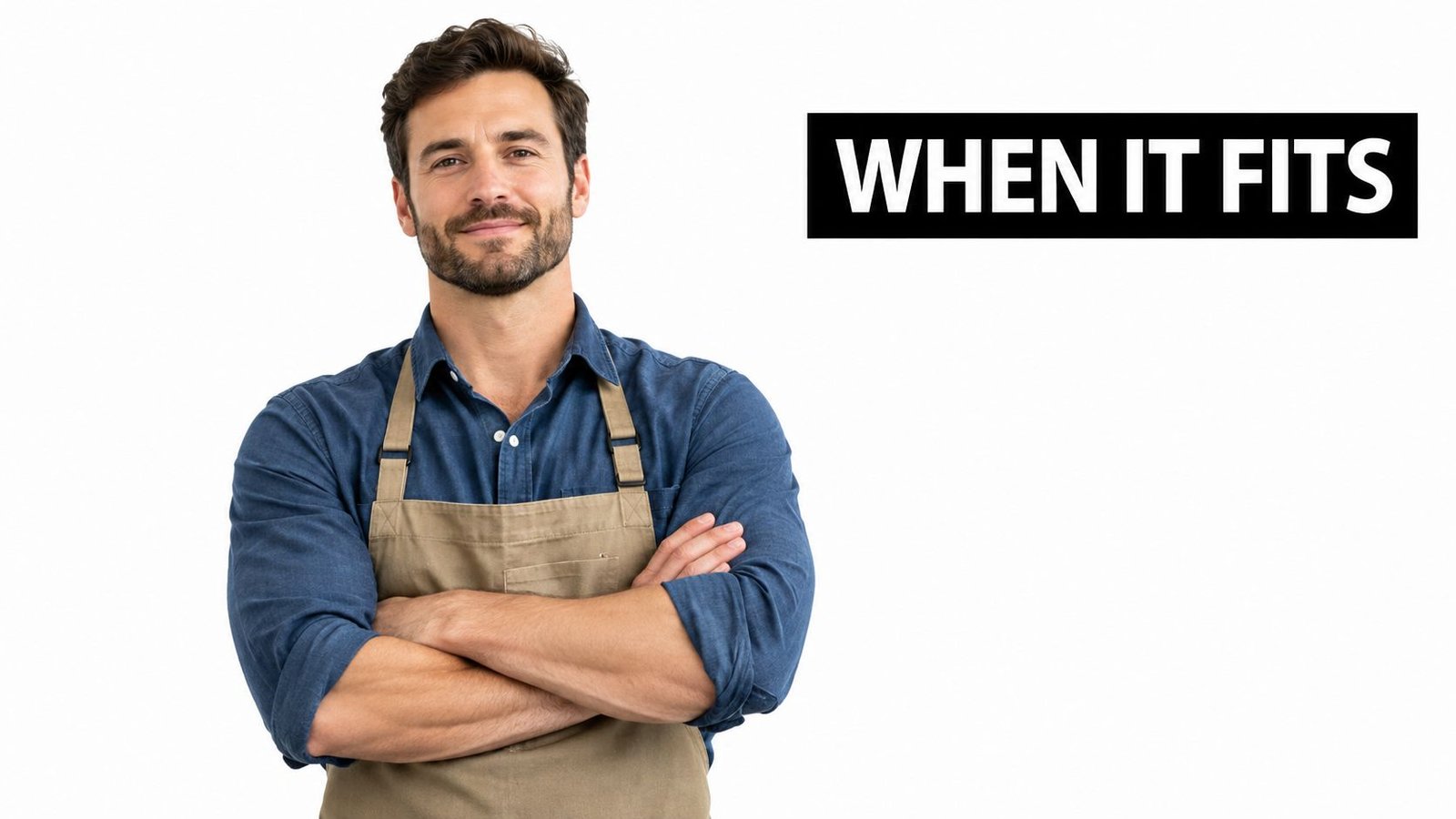 A friendly man wearing a blue shirt and apron with his arms crossed on a white background.
